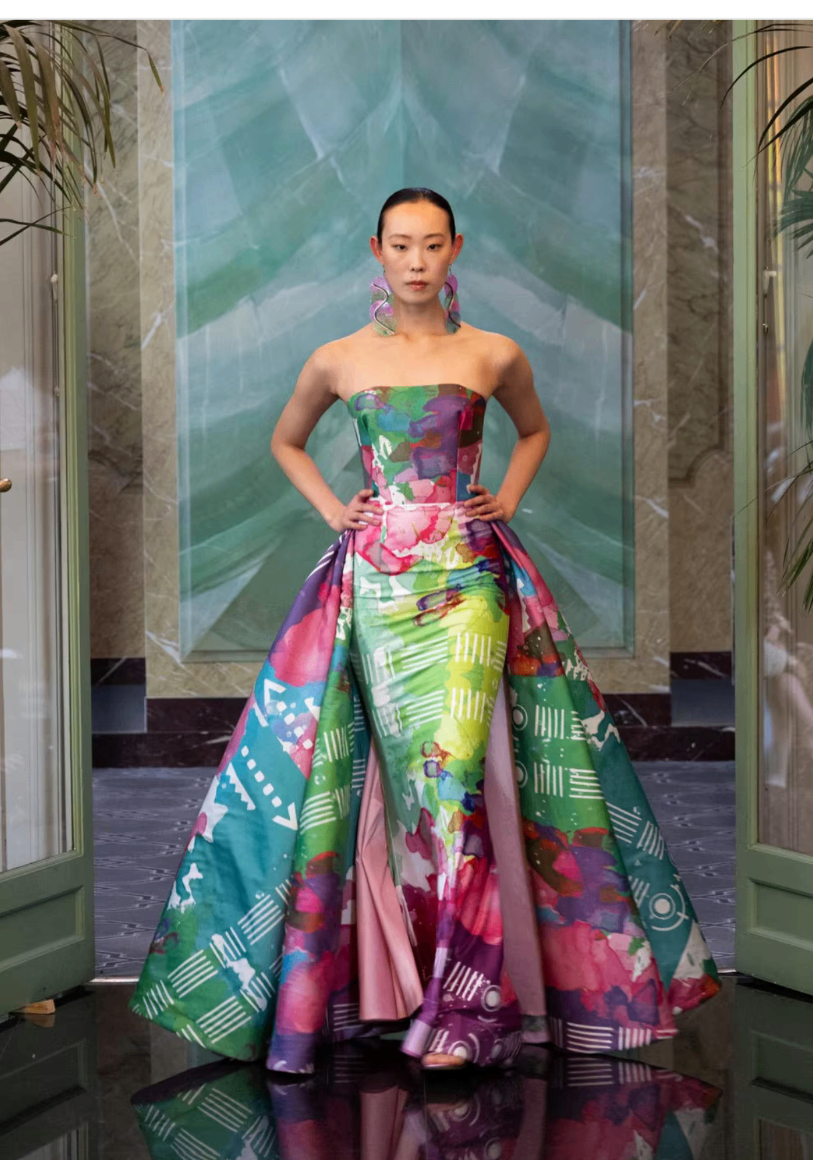Strapless gown in vivid hand-painted greens, pinks and purples with a dramatic overskirt, shown at Paris Fashion Week 2025