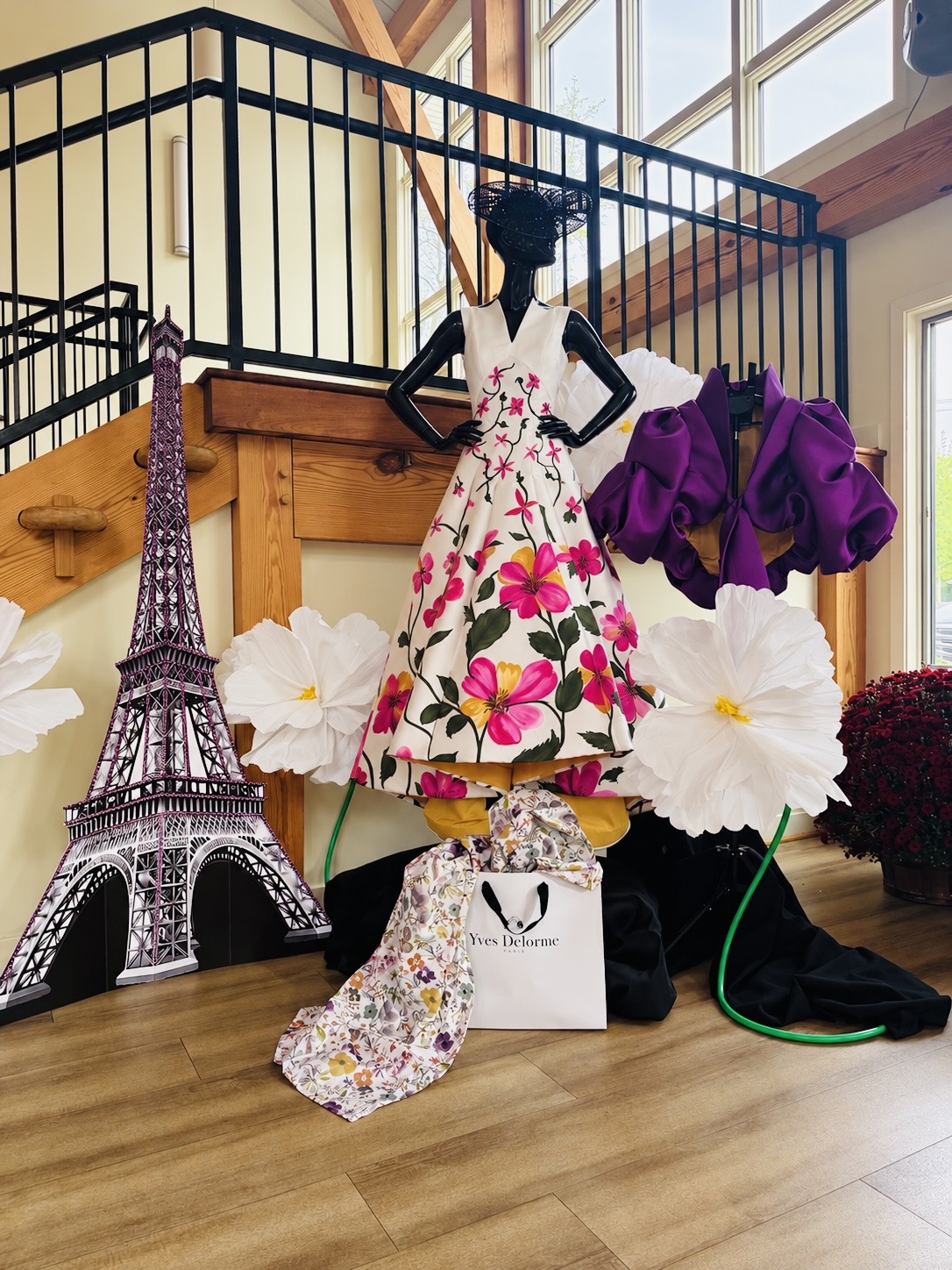 Floral couture dress and purple sculptural garment in a Paris-inspired atelier display